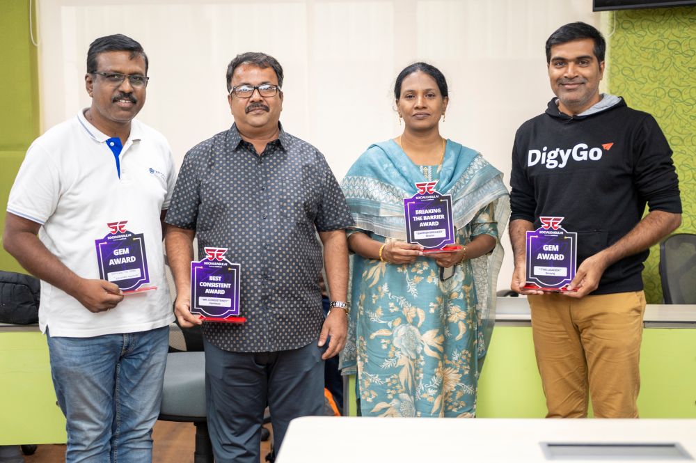 Two men posing together, older with glasses in Social Eagle shirt